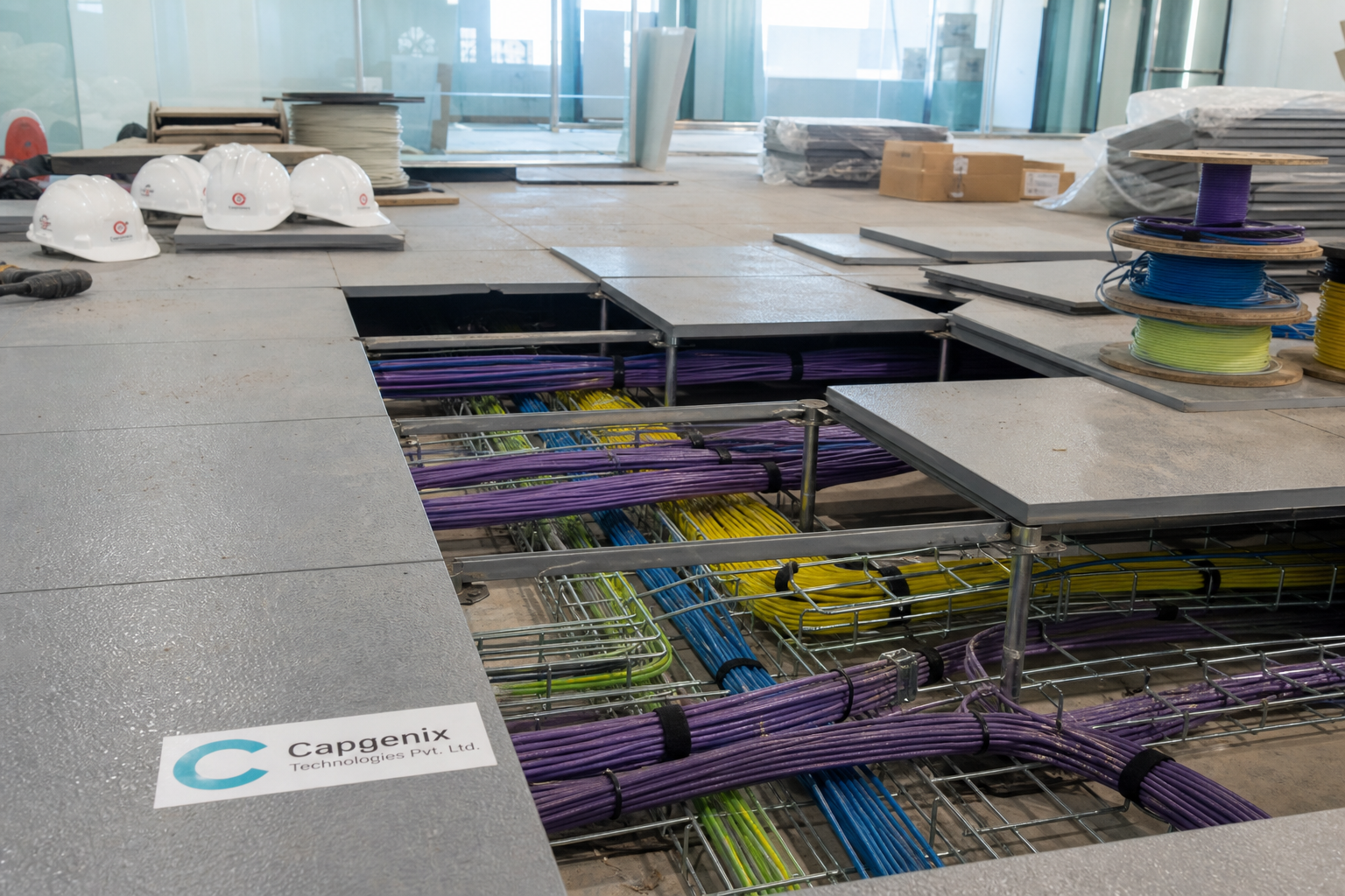 networking solutions in hyderabad - Capgenix technician installing office network cabling